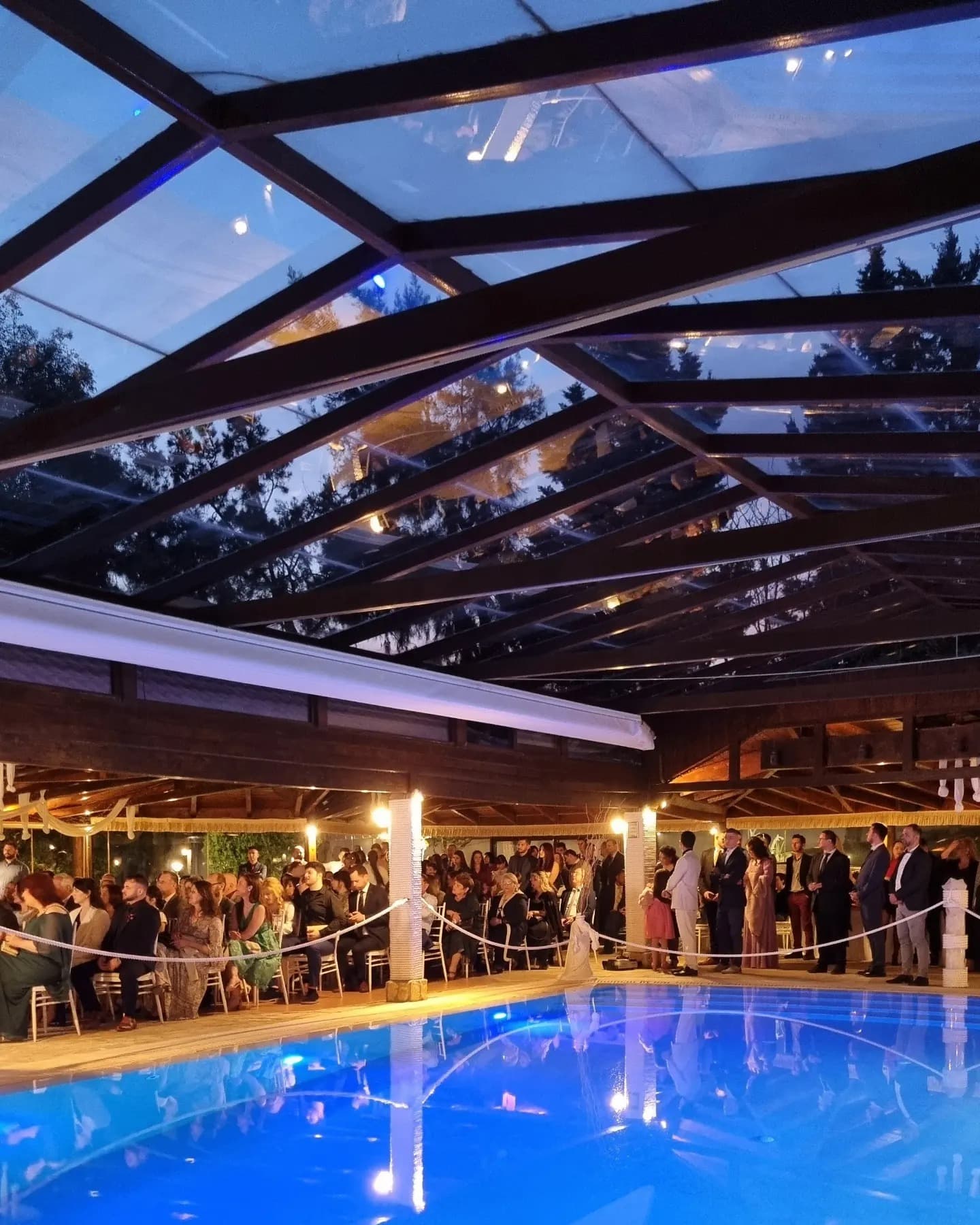 Reception hall with glass roof next to pool — wedding venue Koropi Attica