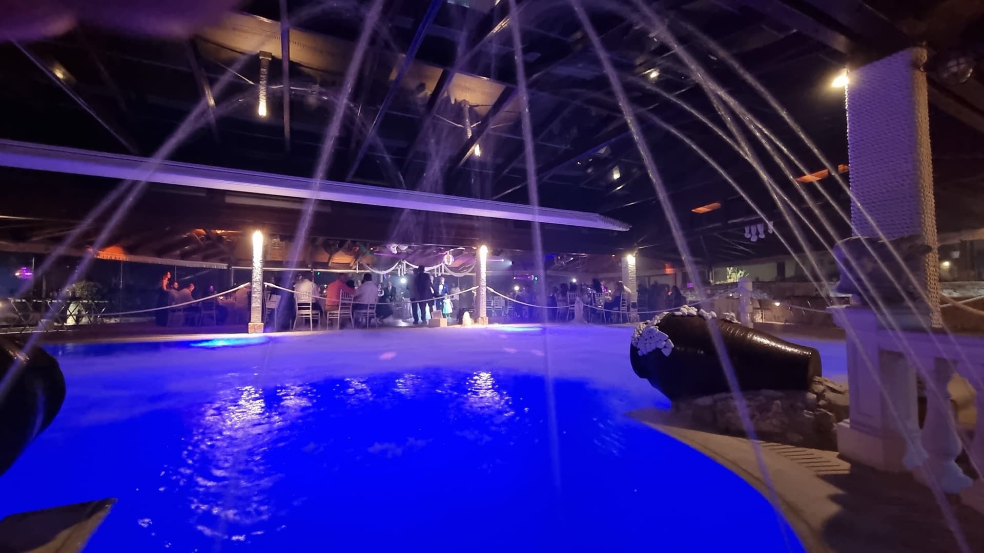 Pool with water fountain jets and glass roof at reception hall Ktima Filokalis Koropi