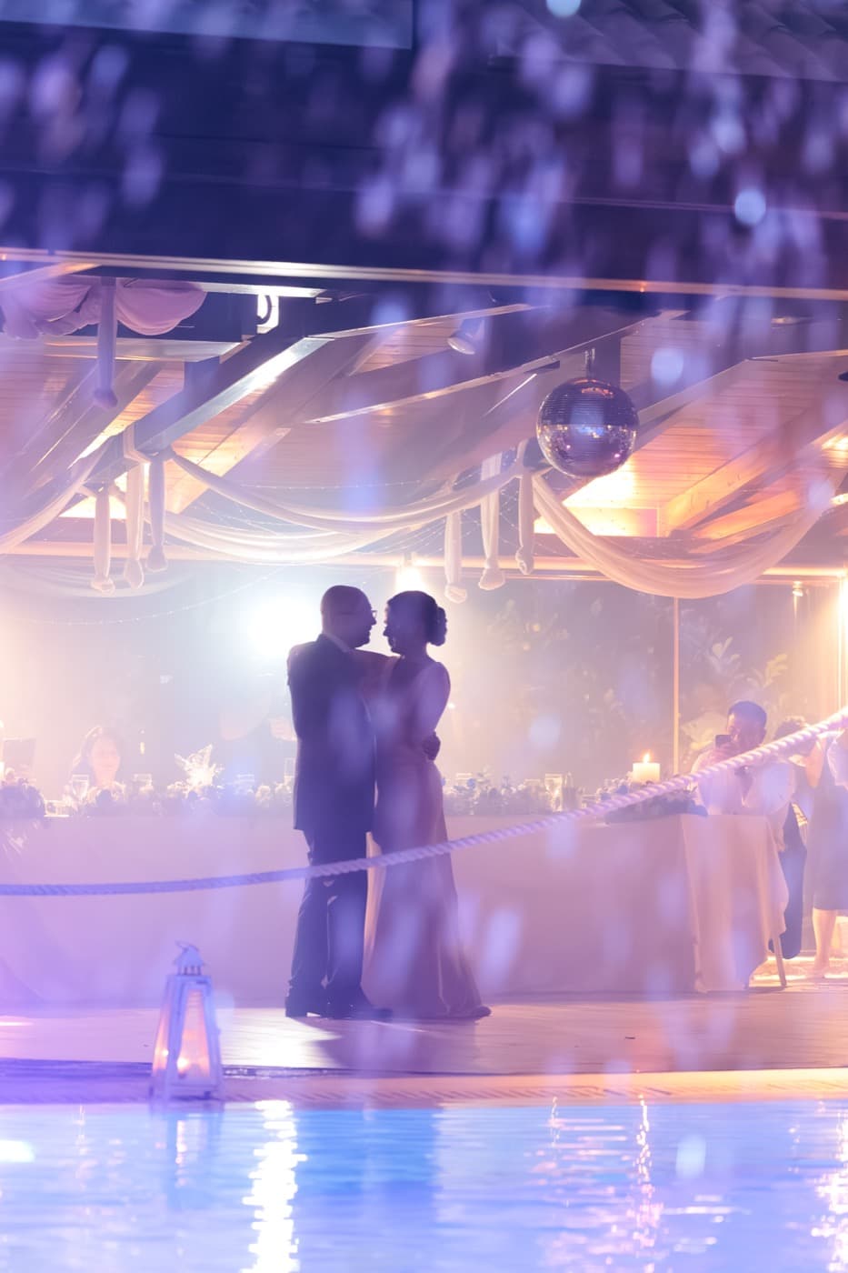Couple silhouette by illuminated pool — wedding reception Ktima Filokalis Koropi