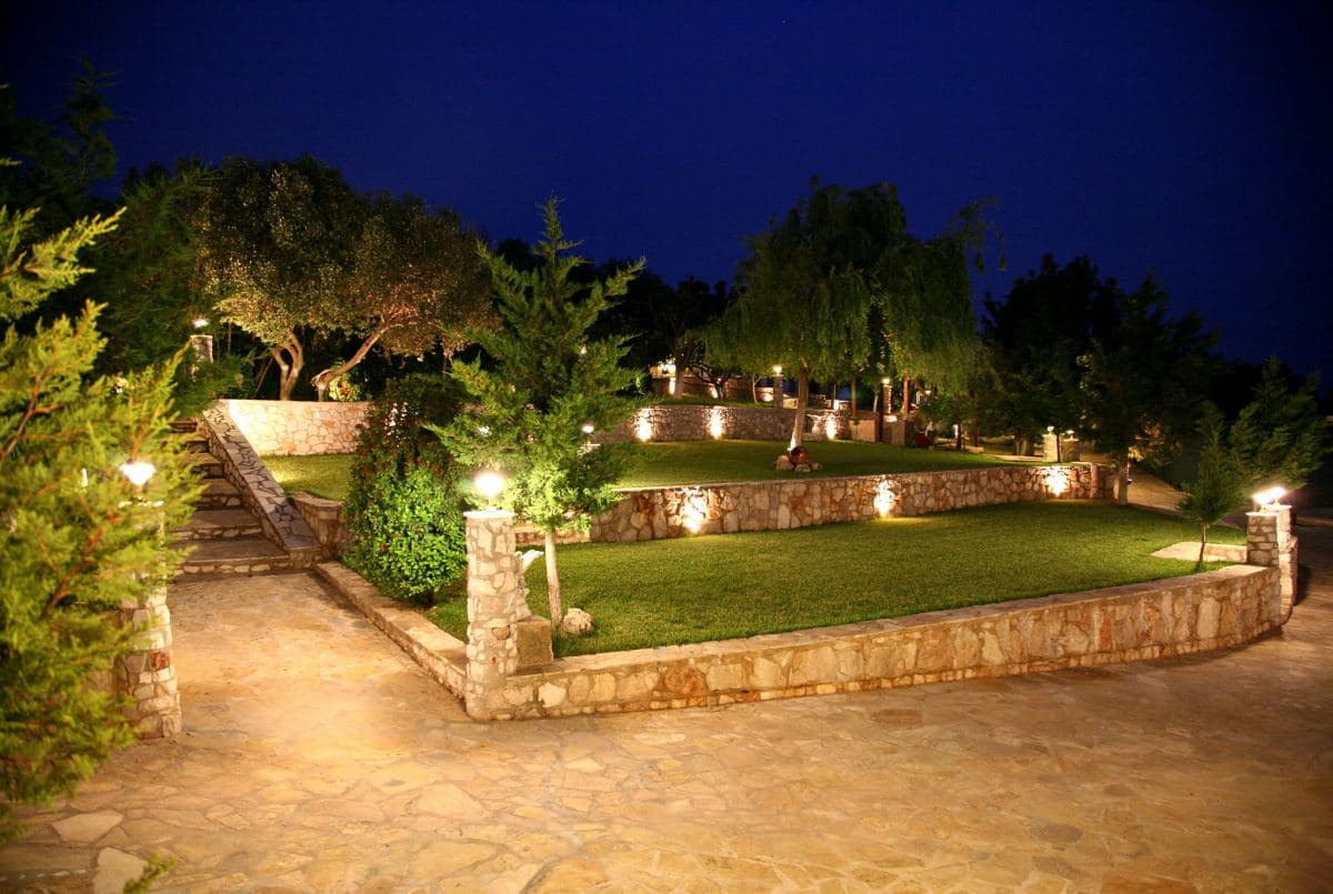 Ktima Filokalis — stone-built outdoor reception spaces with waterfall in Koropi, Attica